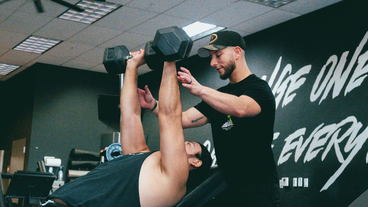 Fitness business owner coaching members inside a boutique gym